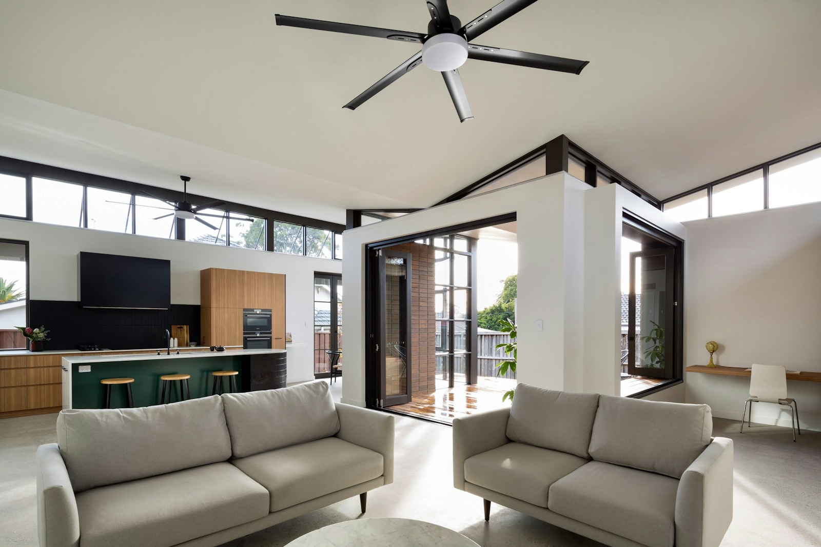 a living room with a large ceiling fan