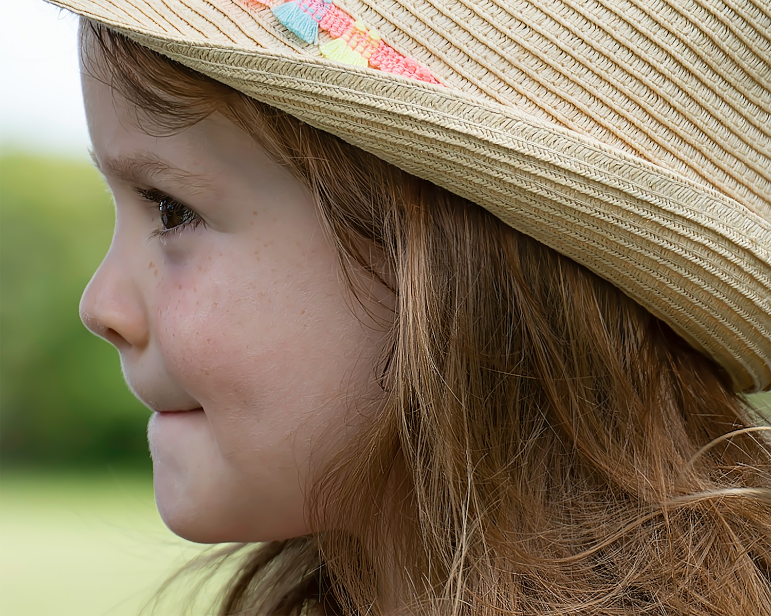 a little girl with a hat on her head