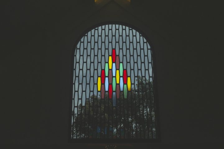 a group of colorful candles in a window